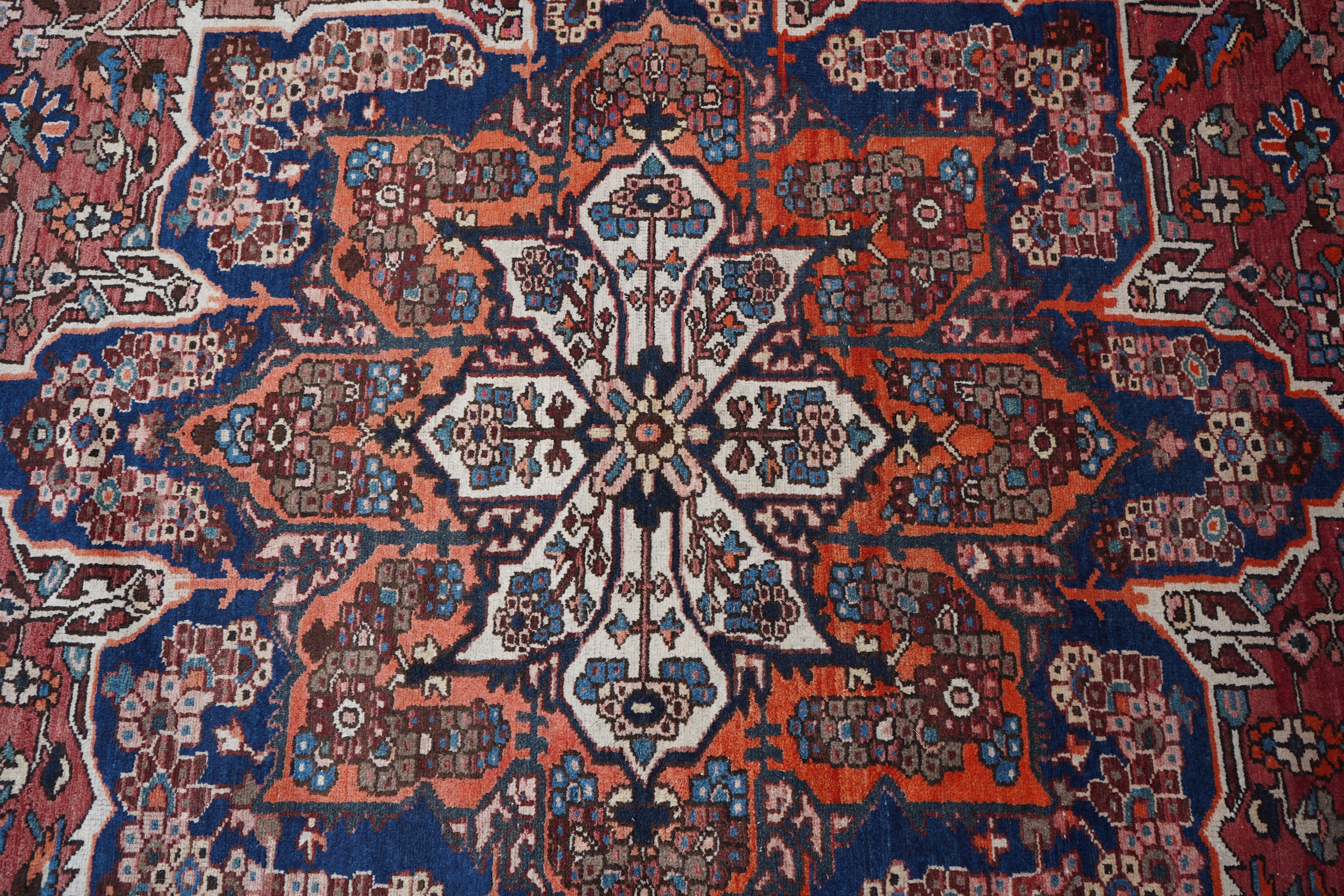 A Heriz brick red ground carpet